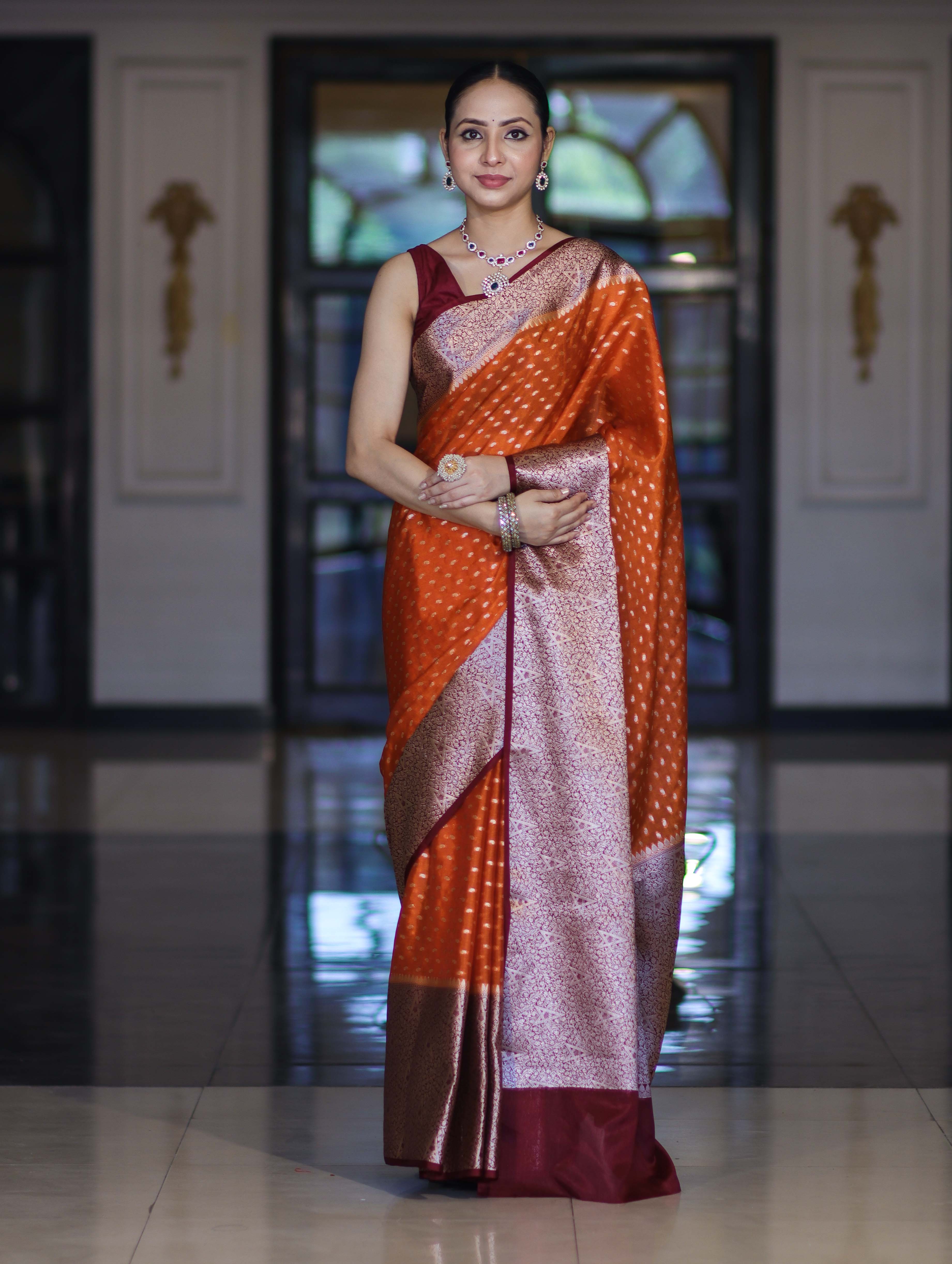 Banarasee Semi Chiffon Saree With Buti Design & Contrast Zari Border-Orange & Burgundy
